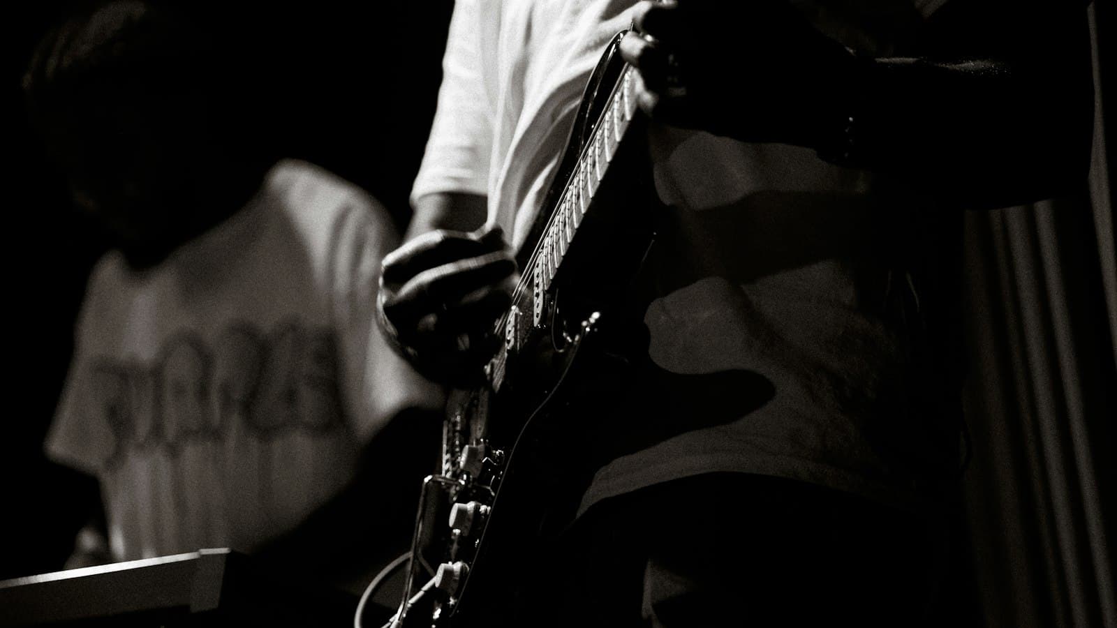 Foto hitam putih Zyho bermain gitar